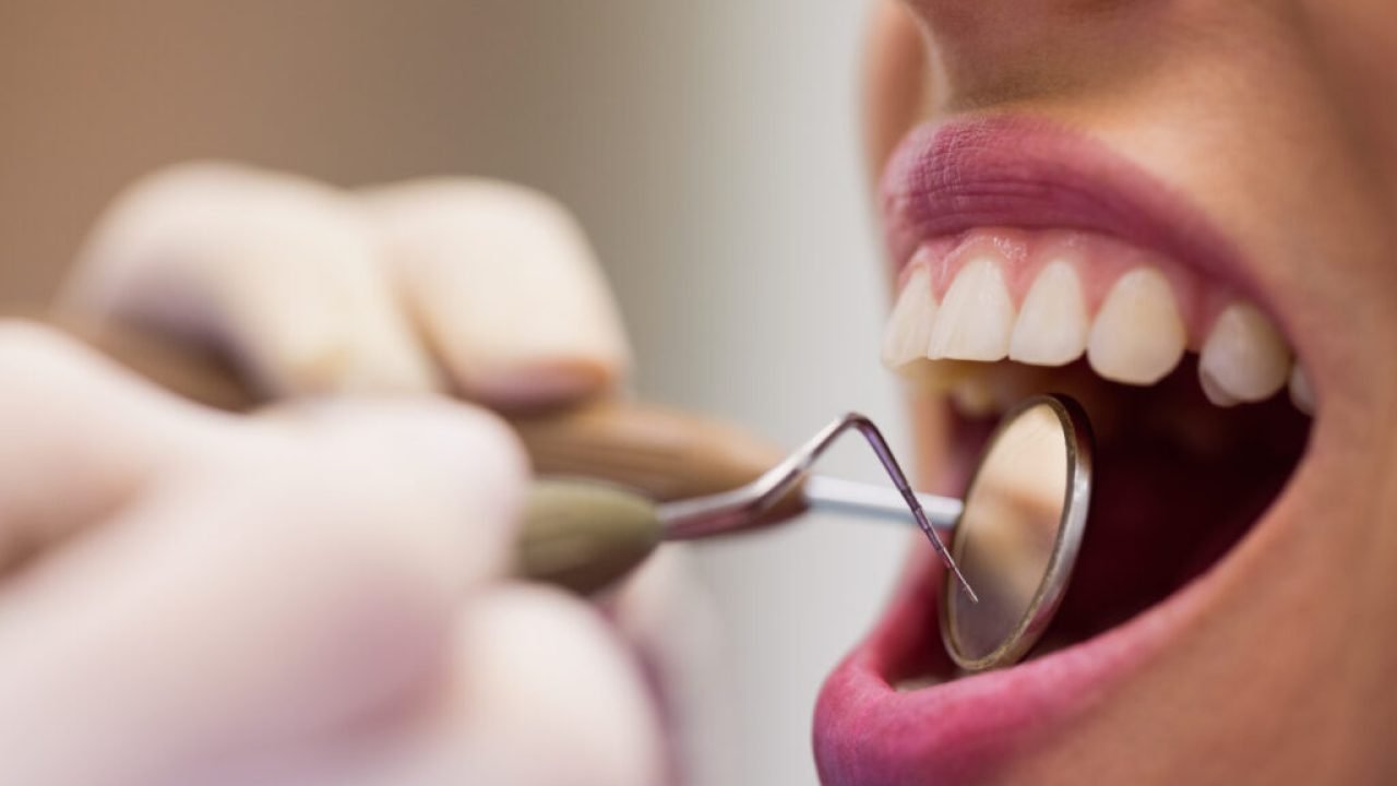 dentist-examining-female-patient-with-tools-1024x683.jpg